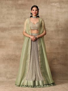 This set features an apple green embroidered raw silk blouse and printed rushed chiffon skirt with chanderi and net detailing paired with scallop embroidered organza cape. Fabric: Organza; Chiffon;... Green Chiffon Skirt, Orang India, Cape Lehenga, Ridhi Mehra, Nikkah Dress, Gaun Fashion, Embroidered Crop Tops, Blouse Skirt, Indian Dress