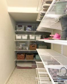 an empty closet with shelves and bins filled with items