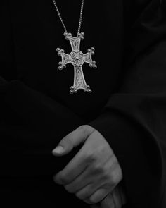 black and white photograph of a person holding a cross