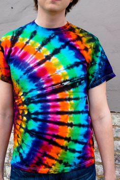 a young man wearing a colorful tie - dyed t - shirt