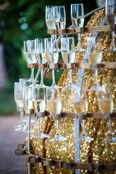 many champagne glasses are stacked on top of each other