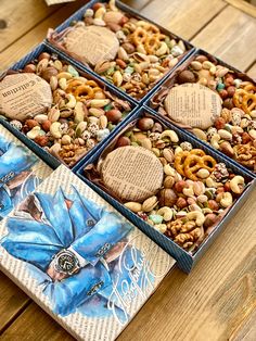 three boxes filled with assorted nuts and pretzels