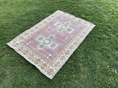 an old rug is laying on the grass