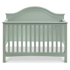 a green crib with white sheets on the bottom and sides, in front of a white background