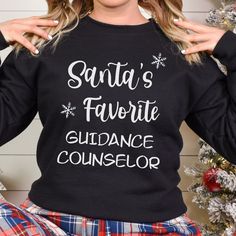 "PLEASE READ! IMPORTANT HOLIDAY INFORMATION Christmas Order Deadline: December 10th Current processing time 1-5 business days 3-8 Business day shipping  WE CANNOT GUARANTEE EXACT SHIPPING DATE Please Read \"Holiday F&Q\", before placing your order Looking for a fun sweatshirt for a guidance counselor to wear this holiday season? Look no further than our Santa's favorite guidance counselor Christmas shirt! This comfortable and stylish sweatshirt is perfect for school counselors to wear to school or for holiday parties. Plus, it makes a great gift for any counselor or your favorite school guidance counselor! Gildan Sweatshirt ☺The Gildan 18000 unisex crew neck sweatshirt is simply the BEST, softest sweatshirt in the industry! ☺Made in the USA! ☺Pre-shrunk fabric to keep the shape of the fabr Massage Therapist Gifts, School Counselor Gifts, Party Sweaters, Gildan Sweatshirt, Funny Santa, Nurse Christmas, Nurse Sweatshirt, Simply The Best, Stylish Sweaters