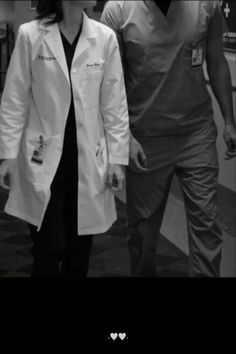 black and white photograph of two doctors walking together