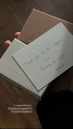 someone is holding two envelopes with writing on them and one has a handwritten thank you for support