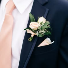 a man in a suit and tie wearing a boutonniere