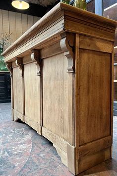 a large wooden cabinet sitting on top of a floor