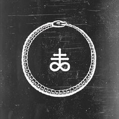 an image of a symbol in the middle of a black and white photo with chains around it