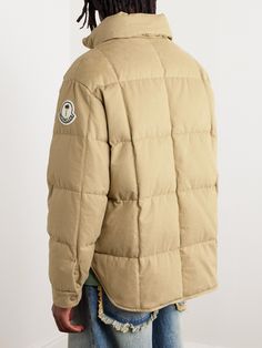 Moncler describes its 'Genius' collection as "a hub for fashion's foremost creatives" and LA-based label Palm Angels is the latest brand to join its list of collaborators. This quilted jacket is made from cotton-gabardine, filled with insulating down and detailed with a dual logo patch at the sleeve. Luxury Cotton Outerwear With Pockets, Luxury Long Sleeve Cotton Outerwear, Designer Beige Cotton Outerwear, Luxury Cotton Outerwear For Streetwear, Luxury Cotton Outerwear For Winter, Luxury Fitted Cotton Outerwear, Designer Fitted Outdoor Outerwear, Designer Outerwear With Padded Collar For Streetwear, Designer Fitted Outerwear For Outdoor