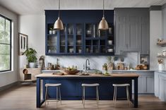 a kitchen with blue cabinets and stools