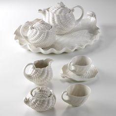 an assortment of white dishes and cups