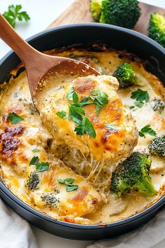 broccoli and cheese casserole in a skillet with a wooden spoon