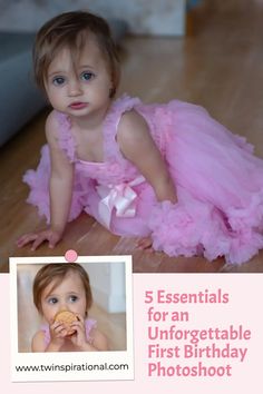 a baby girl wearing a pink dress and holding a donut