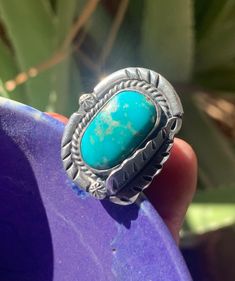 Vintage Navajo turquoise ring, probably from the early 1960s. This Native American Indian ring has a traditional classic setting with twisted rope bezel and a feather or leaf. Size 8 3/4. The pretty eye-catching stone is 3/4 of an inch. Silver setting is 1 inch long. No maker mark and not marked Sterling but that is pretty common for these older rings.  This ring is designed by a creative craftsman with a good eye for stones and flair for style. Check out my other American Indian jewelry! https: Vintage Sterling Silver Turquoise Ring With Large Stone, Western-style Turquoise Ring With Patina, Southwestern Turquoise Rings With Patina, Southwestern Turquoise Ring With Concho, Collectible Bohemian Turquoise Ring, Vintage Concho Ring Jewelry, Bohemian Oval Turquoise Collectible Ring, Western Style Untreated Turquoise Ring, Handmade Western Turquoise Ring Collectible