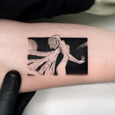 a person with a black and white tattoo on their arm