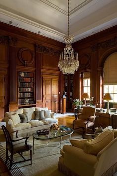 a living room filled with furniture and a chandelier