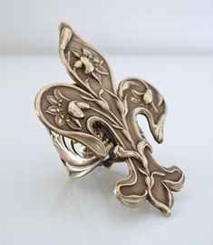 "Vintage Jewelry - Vintage Ring - Art Nouveau Jewelry - Fleur de Lis Ring - Vintage Brass Jewelry - Statement Ring - handmade jewelry This is such a cool ring! A gorgeous large Art Nouveau Fleur de Lis design set on a wide floral adjustable ring band. All USA vintage brass. It is adjustable and can fit on any finger. Just gorgeous! Chloe says, \"Wear it and feel fabulous!\" The ring measures stunning 2 1/4\" long and 1 1/2\" wide. Adjustable up to size 9. *Thank you for visiting Chloe's*" Vintage Adjustable Rings With Unique Design, Handmade Adjustable Antique Rings, Unique Bronze Rings For Gifts, Unique Bronze Rings For Gift, Handmade Bronze Wedding Ring, Artistic Collectible Jewelry Ring, Unique Rings With Lost Wax Casting As Gift, Art Nouveau Sterling Silver Rings As Gift, Art Nouveau Sterling Silver Rings As A Gift