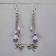 "Dragonfly Earrings Dangle Drop Chain Earrings Lavender Crystal Earrings Lavender Flower Bead Earrings Sterling Silver Plated Wires Be sure to check out my dragonfly ear cuffs too! These super cute dragonfly with lavender flower earrings hang 2 1/4\" from the ear wires.  The chain is silver plated stainless steel.  They have cute dragonfly charms and glass flower beads.  They have glass crystal beads.  They are wire wrapped for added security. The ear wires are sterling silver plated. They will Nickel-free Purple Dangle Chandelier Earrings, Lavender Dangling Beads For Jewelry Making, Purple Metal Dangle Earrings, Purple Dangle Metal Earrings, Nickel-free Purple Chandelier Earrings Gift, Lavender Dangle Earrings With Ear Wire, Lavender Dangle Flower Earrings As Gift, Purple Dangle Earrings With Beads, Lavender Dangle Flower Earrings For Gift