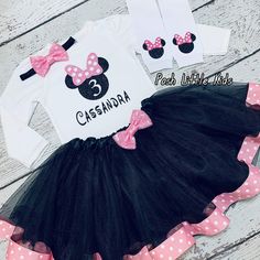 a minnie mouse outfit with pink and black polka dots on the bottom is shown in front of a white shirt that says,