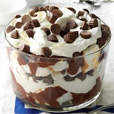 a trifle in a glass dish with chocolate chips and whipped cream on the top