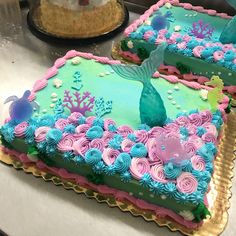 two decorated cakes sitting on top of a table