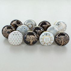 a bunch of buttons sitting on top of a white table next to eachother