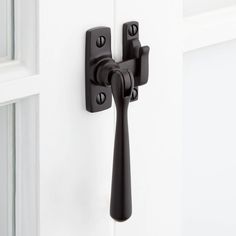 a black door handle on a white door