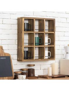 a wooden cabinet sitting on top of a counter next to a chalkboard and coffee pot