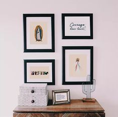 a dresser with pictures on the wall above it