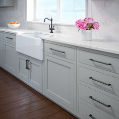 a kitchen with blue cabinets and white counter tops