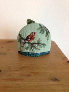 a small bird sitting on top of a wooden table