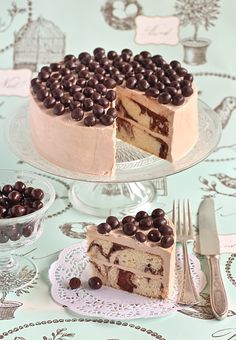 there is a cake with chocolate chips on the top and one slice has been cut