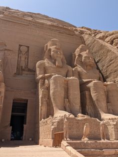 the entrance to an ancient egyptian temple with statues