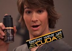 a young man holding up a bottle of deodorant