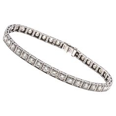 Platinum line bracelet. This marvelous vintage platinum diamond line bracelet features round faceted, European cut diamonds, approximately 3.72 TCW, ranging in clarity from VS2 to Si2, and are J to K color. The stones are prong set into square milgrain edged links, and the bracelet has a hidden box clasp, with a fold over safety clasp. Marks: Irid/Plat Dimensions: 7 1/16" long x 3/16" wide Weight: 8.8 gross dwt Bracelet Tennis, Bracelet Diamond, Box Clasp, European Cut Diamonds, Lorde, Vintage Bracelets, Vintage Diamond, Tennis Bracelet, Arm Band