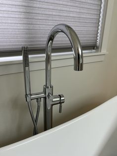 a white bath tub sitting next to a window