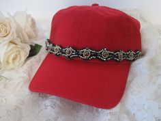 I designed this light weight red trucker baseball hat with gorgeous rhinestone and beaded trim. Perfect for those bad hair days. Has a adjustable pony tail back. See more of my trucker baseball cadet hats here: https://www.etsy.com/shop/theraggedyrose?ref=seller-platform-mcnav&section_id=10557807 Thanks for visiting my shop Adjustable Baseball Cap With Bling, Casual Adjustable Baseball Cap With Rhinestones, Rhinestone Baseball Cap One Size, Rhinestone Embellished One Size Baseball Cap, Adjustable Rhinestone Baseball Cap With Curved Brim, Trendy Rhinestone Adjustable Baseball Cap, Adjustable Rhinestone Cap, Red Adjustable Fitted Hat With Short Brim, Red Adjustable Fitted Baseball Cap