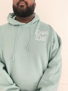 Screen Printed Dope Dad Design Pocket Style made with a cozy 50/50 cotton/polyester blend. Featuring a comfortable hood with a matching drawcord and a convenient pouch pocket, this hoodie is perfect for anyone with its versatile unisex sizing. Choose a range of trendy colors including ocean blue, pecan, coral, heather grey, and classic black, all adorned with white ink color. Soft and cute to wear oversized must-have hoodie. Size and Fit: Choose normal size for relaxed fit. Urban Cotton Hoodie With Drawstring, Cotton Sweatshirt With Drawstring And Crew Neck, Cotton Crew Neck Sweatshirt With Drawstring, Cozy Cotton Hoodie With Kangaroo Pocket, Green Casual Hoodie With Drawstring, Casual Green Hoodie With Drawstring, Comfortable Streetwear Hoodie With Drawstring, Green Cotton Sweatshirt With Double-lined Hood, Cozy Cotton Hoodie With Drawstring Hood