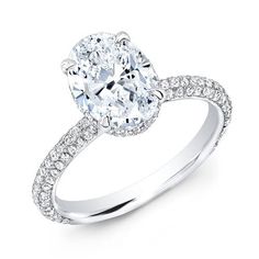 an oval cut engagement ring with pave set diamonds on the shoulders and sides, in 18k white gold