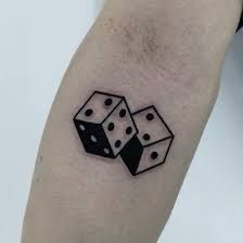 two dice tattoo on the left arm