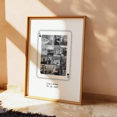 a framed photograph sitting on top of a floor next to a wall with a black and white photo in it