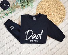 Custom Dad Est with Kids Names Sweatshirt, Personalized Dad Hoodie, Gift for Dad, Fathers Day Gift Idea for Husband, Custom Daddy Sweater Welcome to Custom Fashion Tees! Size & Colors; For  size and color options,  please look at listing images. Gildan Brand, 50% cotton, medium weight and soft touch. Usually runs true size.  DTF printing method is used for these sweatshirts. 𝗛𝗢𝗪 𝗧𝗢 𝗢𝗥𝗗𝗘𝗥: 𝟏. Please, check and review listing photos. 𝟐. Select Your Sweatshirt or Hoodie size and color from drop down menus. 3. Choose Your Quantity you want. 𝟒. Click 𝗔𝗗𝗗 𝗧𝗢 𝗖𝗔𝗥𝗧. Go to your card and finish your order. CARE INSTRUCTIONS: Turn the sweatshirt or hoodie inside out. Machine wash cold with mild detergent. Tumble dry very low. Do not use bleach. Do not iron directly on design. RE Gift Idea For Husband, Dad Sweater, Sweater Ideas, Kids Names, Dtf Printing, On Design, Gift For Dad, Kid Names, Fashion Tees