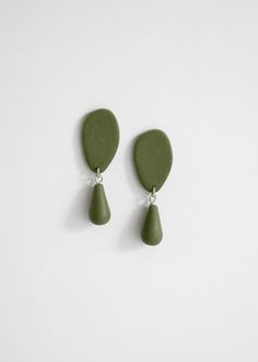 two green drop earrings on a white background