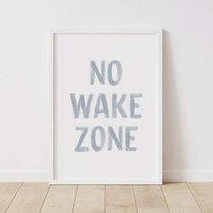 a white framed poster with the words no wake zone written in black ink on it