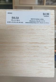 a close up of a piece of wood with a price label on the back of it