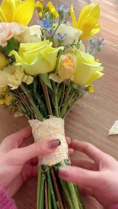 a person is wrapping flowers with tape