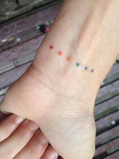 a person's foot with small dots on it and the word love written in different colors