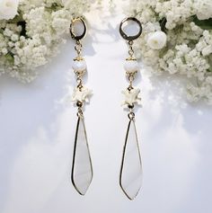 Enhance your bridal look with these extraordinary "Serpentine Elegance Bridal Earrings," a perfect blend of delicate beauty and bold style. These earrings are meticulously crafted to capture attention and add a touch of elegance to your special day. These earrings feature an elongated, teardrop-shaped mother of pearl charm that reflects light beautifully, offering a subtle, iridescent shimmer that complements any bridal gown. Adding an unexpected and unique element, each earring includes a genui Metal Dangle Linear Earrings For Weddings, Long Drop Metal Wedding Jewelry, Metal Linear Earrings For Wedding, White Dangle Clip-on Jewelry, White Clip-on Dangle Bridal Earrings, Metal Linear Earrings For Pierced Ears For Wedding, White Metal Dangle Bridal Earrings, White Metal Dangle Linear Earrings, White Dangle Clip-on Hoop Earrings